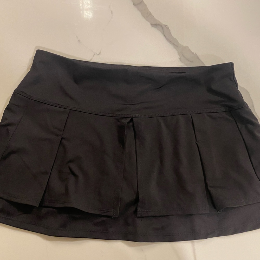 Lucky in Love black tennis skirt w/ pleated detailing in front and back. Size s